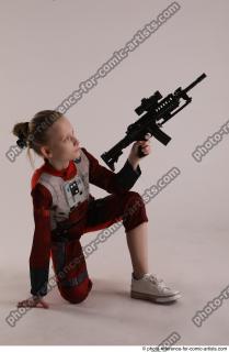 DENISA KNEELING POSE WITH GUN
